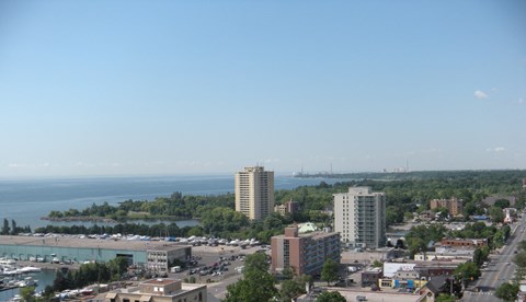a view of the city with the ocean in the background